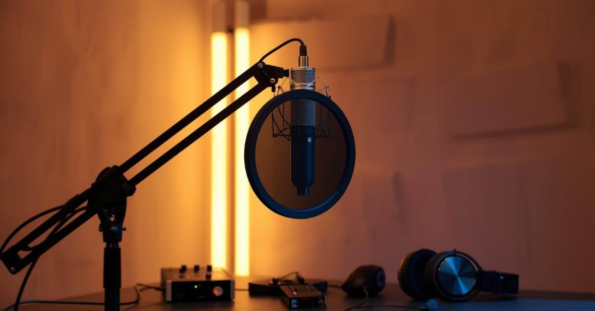 Home studio setup with the best recording microphone on a boom arm, surrounded by acoustic treatment for clear and professional voice recordings.
